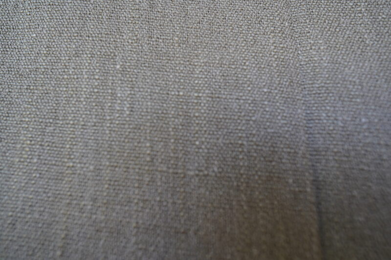 High-quality linen fabric product promotional image, showcasing its natural texture and soft neutral tones, creating an elegant and comfortable atmosphere, suitable for use in sofas, curtains, and home decor